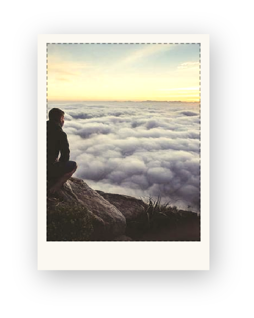 Someone sitting on a cliff above the clouds